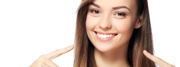 Happy young woman after having teeth whitening treatment