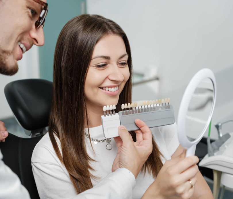 Dentist showing patient veneer options