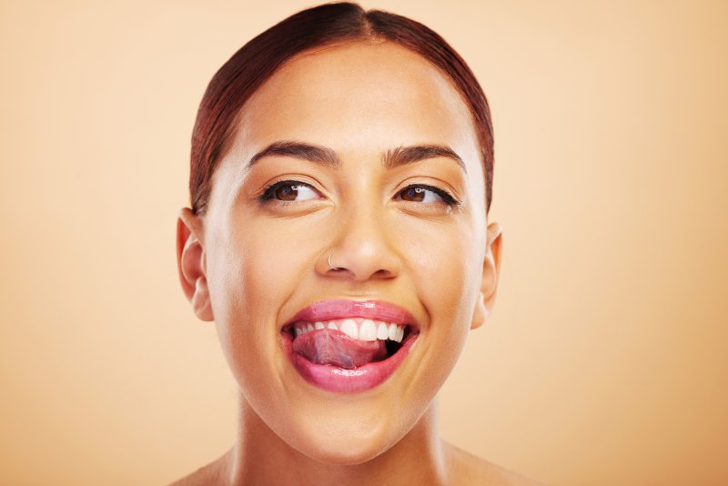 Patient licking teeth after getting veneers